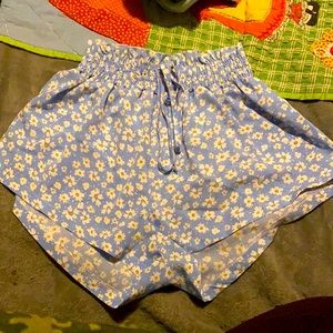 I The shorts are blue with flowers on them with a Fringed top.